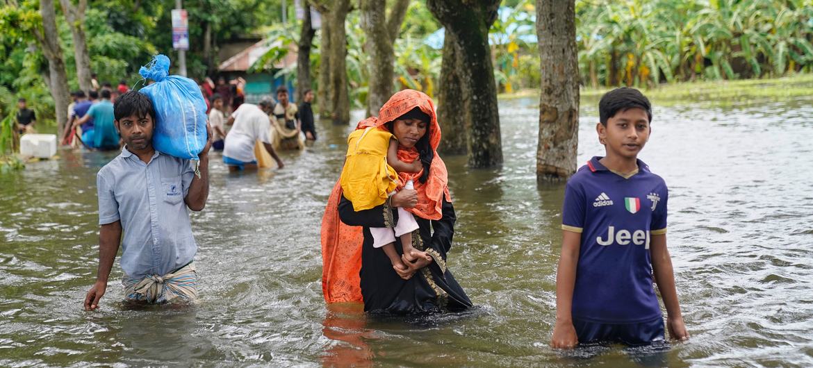 People wading through flood waters in search of shelter in Feni following catastrophic flooding that displaced five million people in southeastern Bangladesh in August 2024. (file)