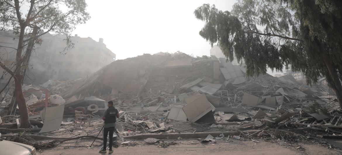 A man looks over a collapsed building in Gaza.