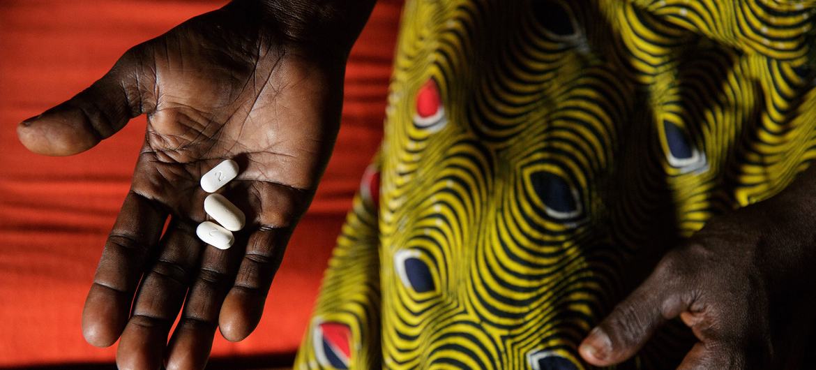 Na Costa do Marfim, Adjoua Yao, que vive com HIV, tem três comprimidos, medicamentos antirretrovirais, que toma todos os dias como parte da sua terapia antirretroviral, na casa da sua irmã, no bairro de Campement, na cidade de Abidjan