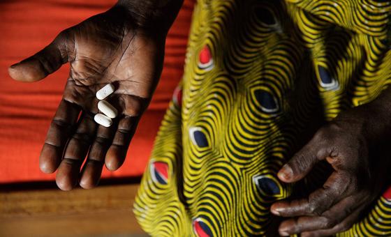 in Côte d’Ivoire, Adjoua Yao, who is living with HIV, holds three pills, antiretroviral (ARV) drugs, she takes each day as part of her antiretroviral therapy (ART), at her sister’s home in the Campement neighbourhood of the city of Abidjan.