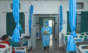 A nurse walks into a hospital ward in Janakpur in Dhanusha District in southern Nepal.