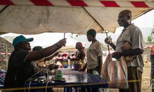 A displaced man receives food at a distribution centre in the eastern DR Congo.