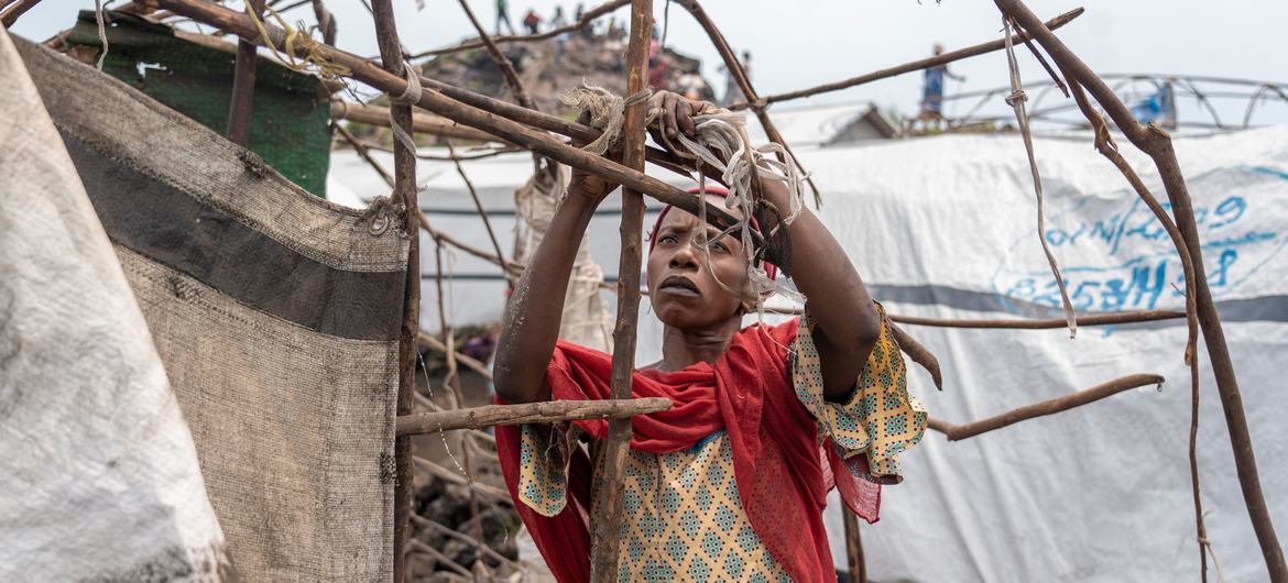 A woman dismantles her shelter at a camp for displaced people on the outskirts of Goma in the eastern DR Congo. A woman dismantles her shelter at a camp for displaced people on the outskirts of Goma in the eastern DR Congo.