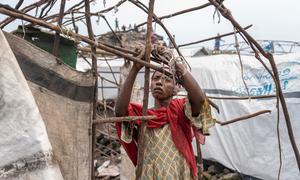 A woman dismantles her shelter at a camp for displaced people on the outskirts of Goma in the eastern DR Congo.