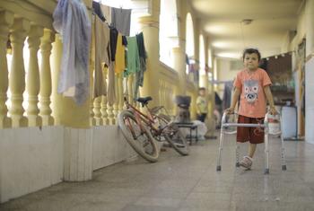 A young girl who lost her parents and siblings in a missile strike on their house is learning to walk again following the amputation of her leg.