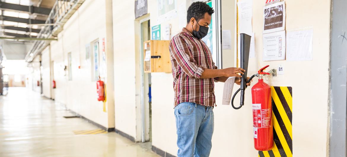 A worker at a factory in Ethiopia carries out an inspection on fire safety equipment. A worker at a factory in Ethiopia carries out an inspection on fire safety equipment.