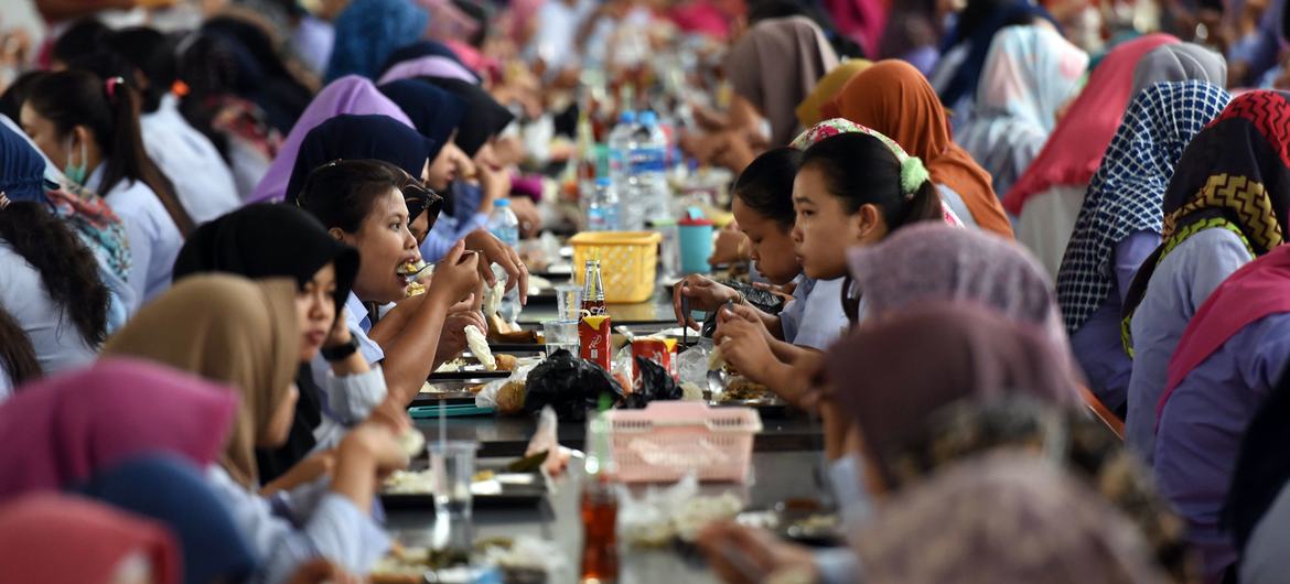Workers take their lunch break at a garment factory in Indonesia. Workers take their lunch break at a garment factory in Indonesia.