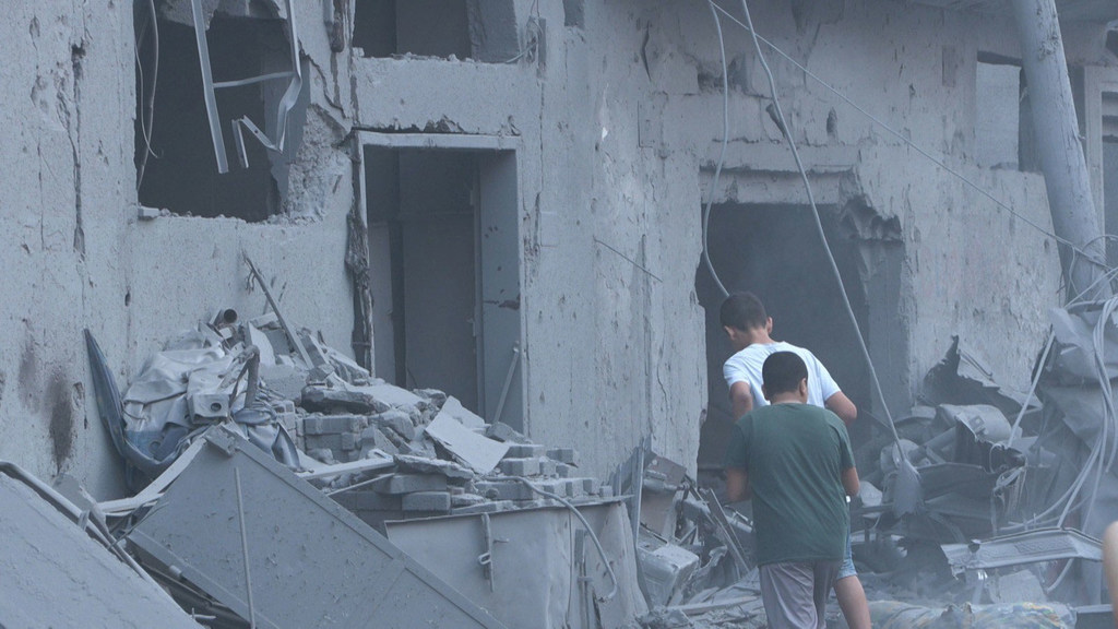 Deux hommes s'approchent d'un bâtiment du centre de Gaza qui aurait été touché par des missiles.