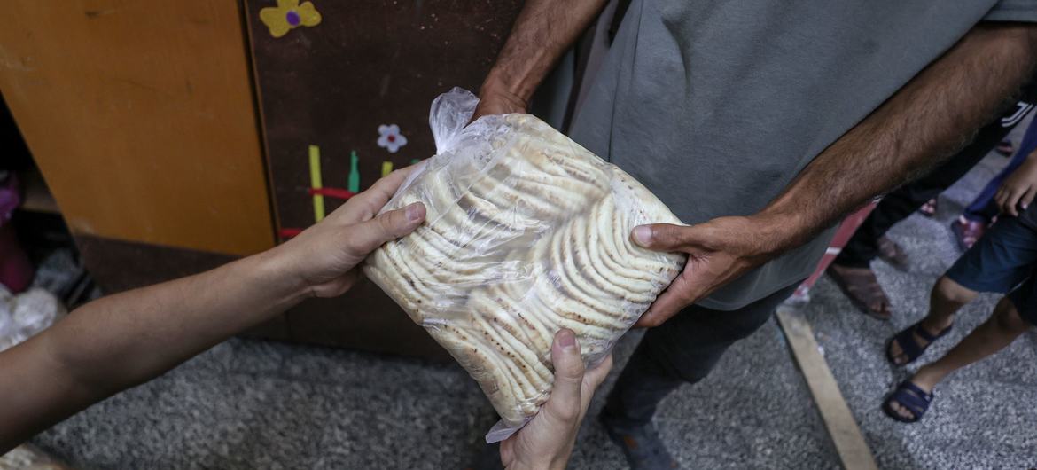 Bread is distributed in a school in Gaza that is a designated shelter in times of emergency.