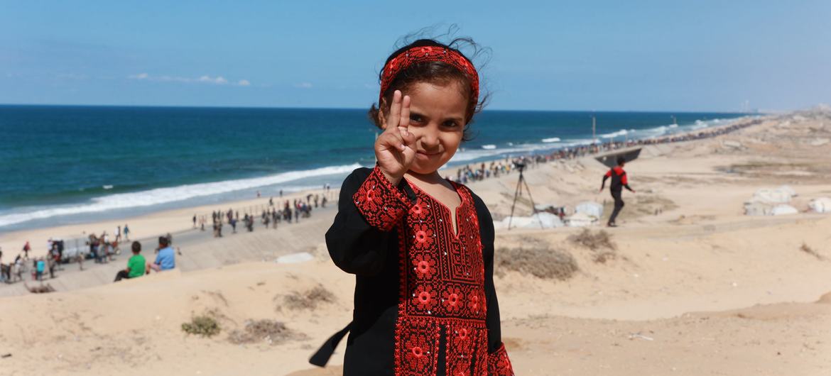 A girl in Gaza makes the peace sign.