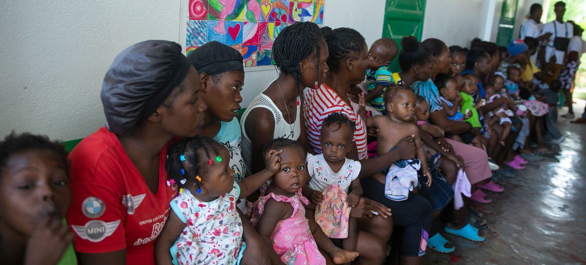 Women and their children wait at a UNICEF-supported mobile clinic in Port-au-Prince, Haiti. (file) 