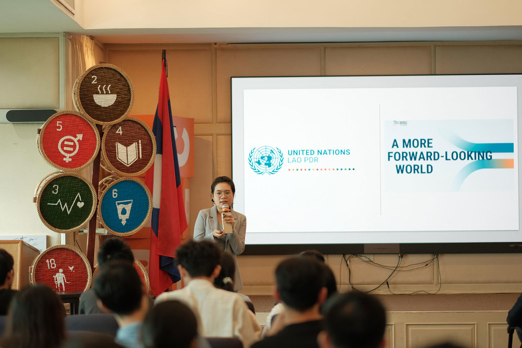 Aksonethip Somvorachit addresses young people at a youth event.