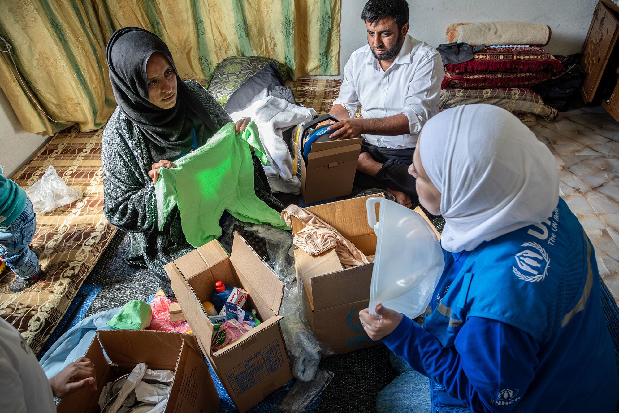 Des vêtements chauds et d'autres articles de première nécessité sont distribués aux familles déplacées à Babekkeh, en Syrie.