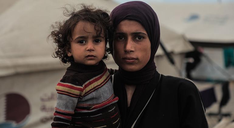 Una mujer palestina y su hijo frente a la tienda en la que viven en la ciudad de Gaza.