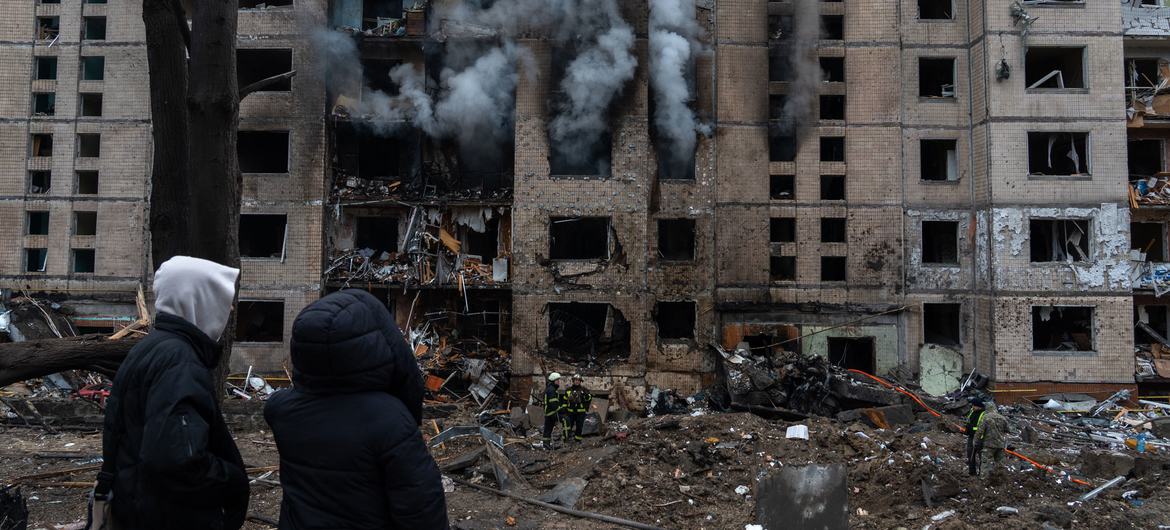 People walk passed a recently bombed building in Kyiv, Ukraine, in January 2024.
