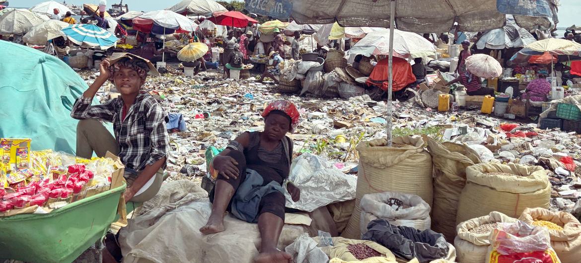 Vendors surrounded by garbage sell goods in Port-au-Prince, Haiti.