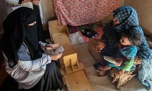 Nurses at a mobile clinic provide nutrition assistance to families in a village in Kandahar, Afghanistan.