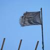 A shredded UN flag flies over a destroyed school building in Khan Younis.