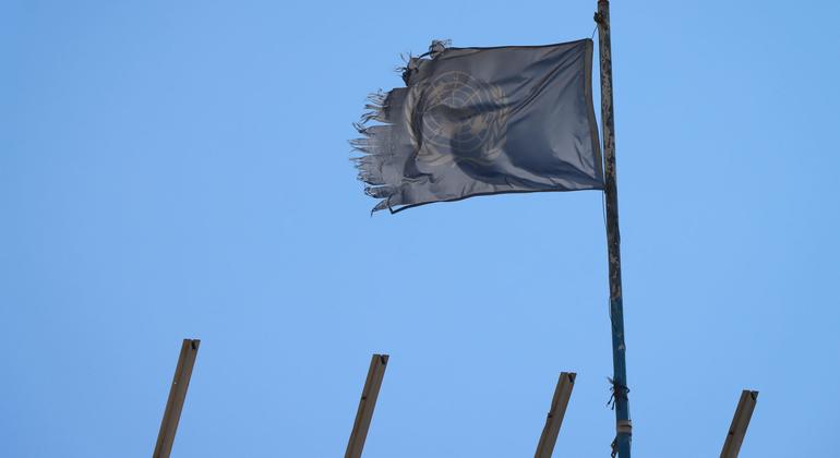 A shredded UN flag flies over a destroyed school building in Khan Younis.