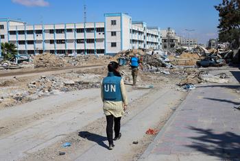 A UN team inspects a destroyed school in Khan Younis.