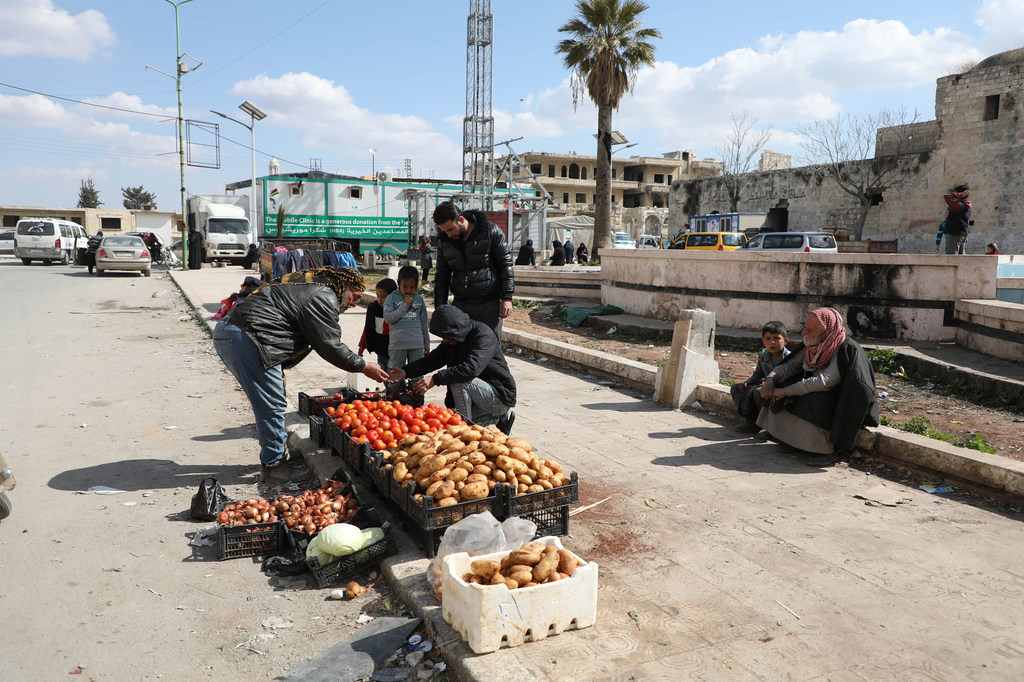 A man sells vegetables on the streets of Idleb in Syria.