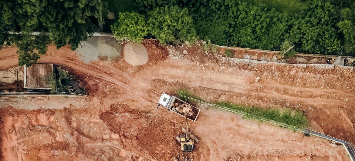 Aerial view of a construction site in Brazil showing sand extraction, heavy machinery, and deforestation.