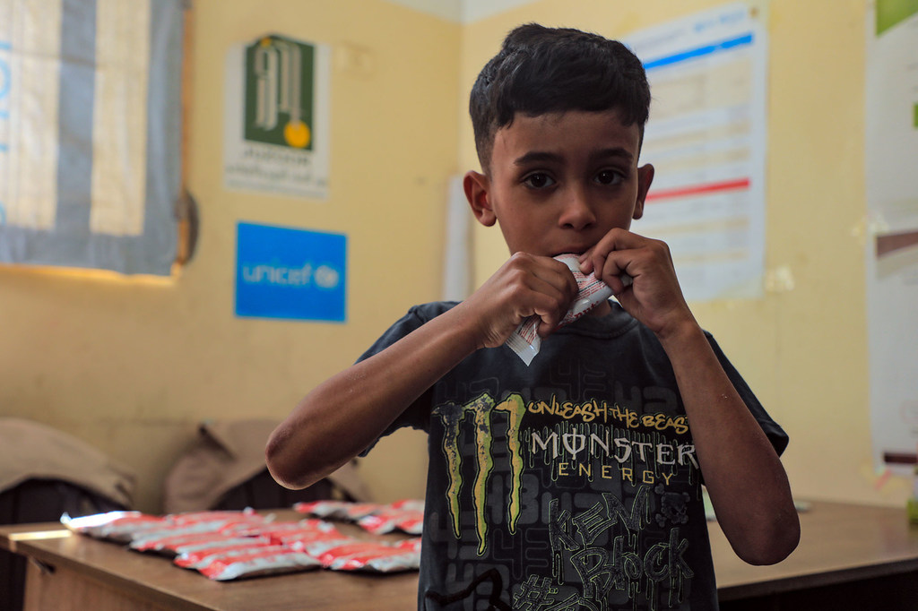 A young boy in Gaza with severe weight loss and malnutrition eats a nutritional supplement. A young boy in Gaza with severe weight loss and malnutrition eats a nutritional supplement.