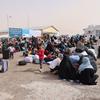 Afghan families who recently arrived from Iran gather at a border crossing in Herat Province, Afghanistan.