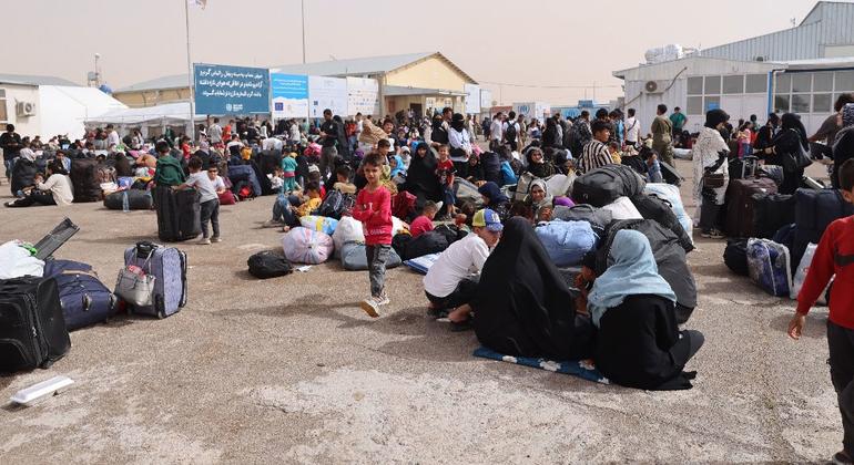 Afghan families who recently arrived from Iran gather at a border crossing in Herat Province, Afghanistan.