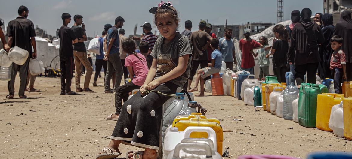 A child queues for water in Gaza.