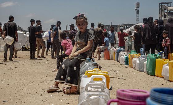 A child queues for water in Gaza.