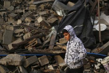 A boy walks past the rubble of destroyed houses in the city of Rafah, in the southern Gaza Strip.