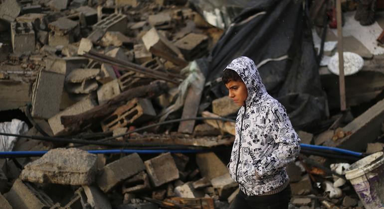 A boy walks thoughtfully as he inspects the rubble of destroyed houses in the city of Rafah, southern Gaza Strip.