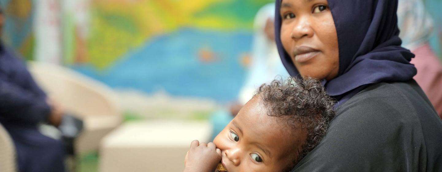 A woman receives support at a UNFPA Safe Space after fleeing Sudan.