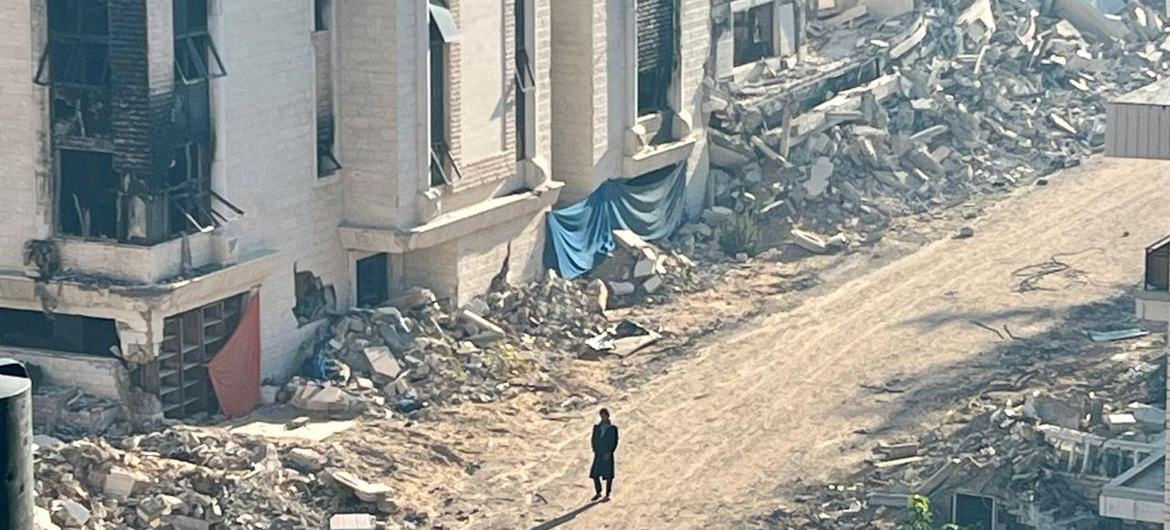 A person walks through a destroyed neighbourhood in Gaza.