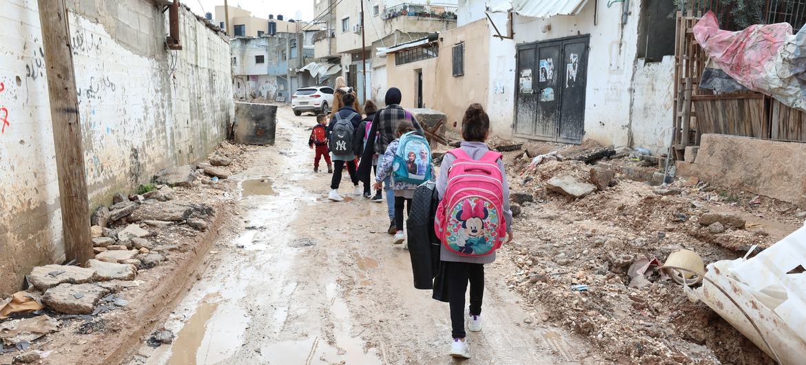 Crianças caminham por ruas parcialmente destruídas em Jenin, na Cisjordânia.