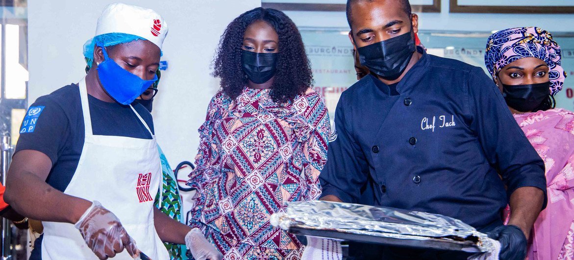 Blessing Ojukwu (left) leant how to cook pastry and other foods at a UN-supported initiative.