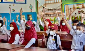 Elementary school students in South Sulawesi province, Indonesia return to class in March 2022 following the outbreak of the COVID-19 pandemic.