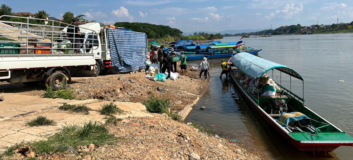 Goods being loaded onto a boat in Lao People's Democratic Republic to be transported across the Mekong river to Thailand. (file)