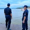 Village security volunteer, Eakkachai Suphan, (left) and a colleague look over the Mekong River in the Golden Triangle. 