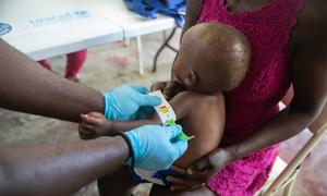 A toddler's arm is measured to determine malnutrition at a clinic run by UNICEF, in Cité Soleil, Haiti.