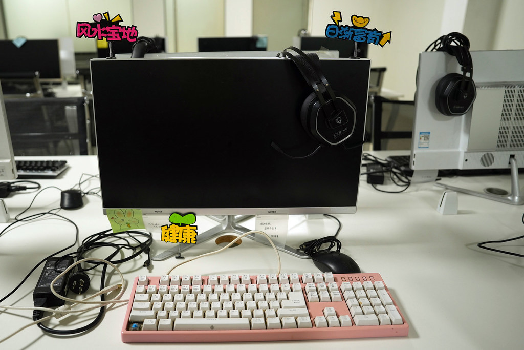 A workstation in a raided scam centre in the Philippines; the text in blue reads ‘increasingly prosperous.’