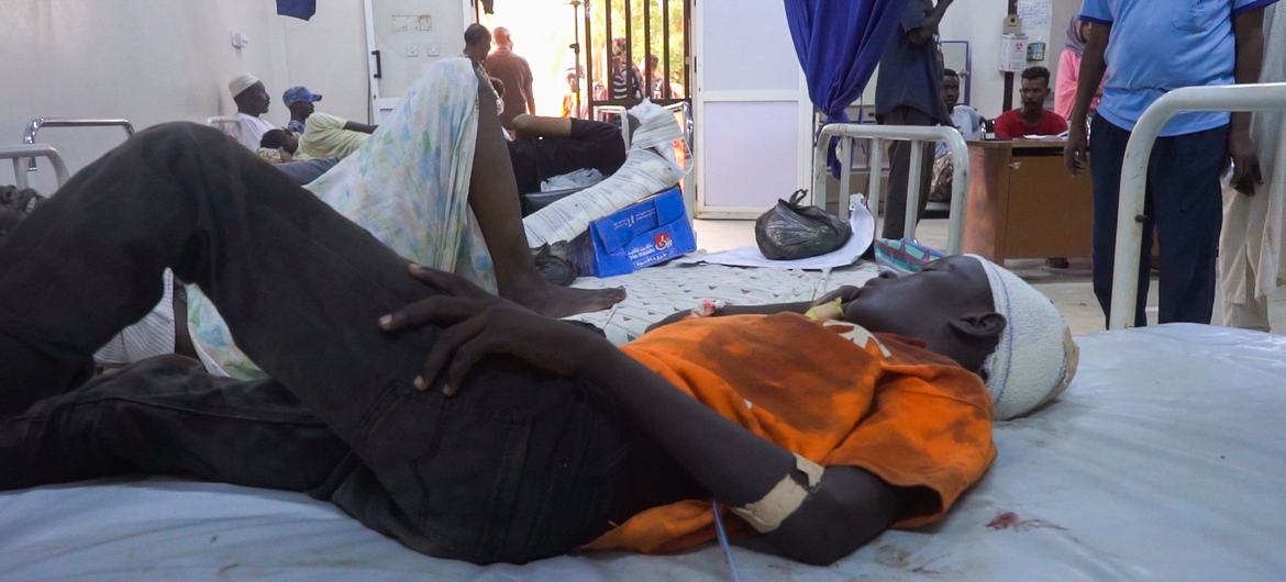 A 13-year-old boy lies on a hospital bed in Al Nau hospital after being hit by shrapnel at a UNICEF child-friendly space in Khartoum.