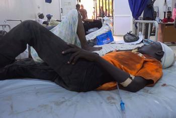 A 13-year-old boy lies on a hospital bed in Al Nau hospital after being hit by shrapnel at a UNICEF child-friendly space in Khartoum.