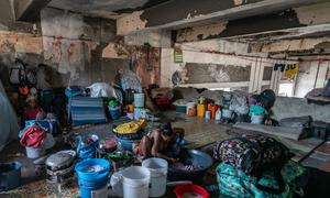 A displaced woman washes clothes at a disused theatre in downtown Port-au-Prince, Haiti.