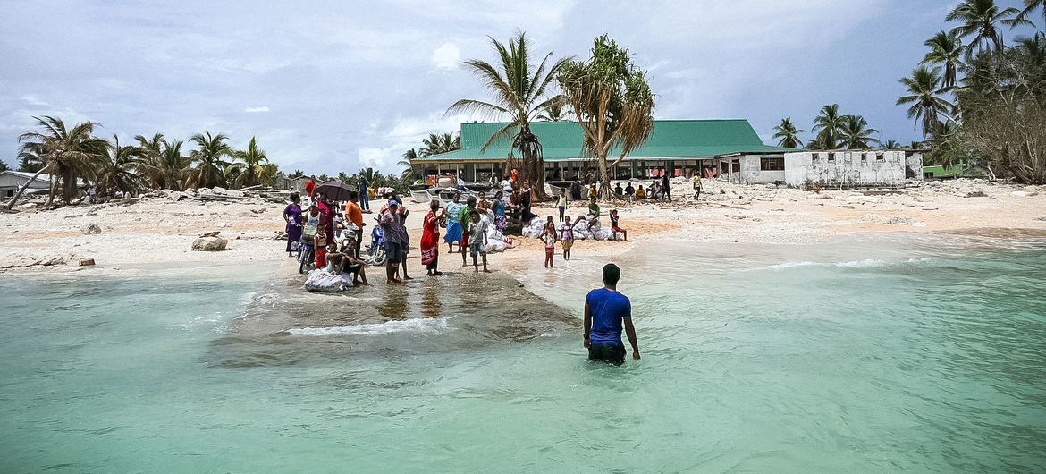 The community of Nui island waves goodbye to the Prime Minister of Tuvalu following his visit in the aftermath of the destruction of Cyclone Pam.