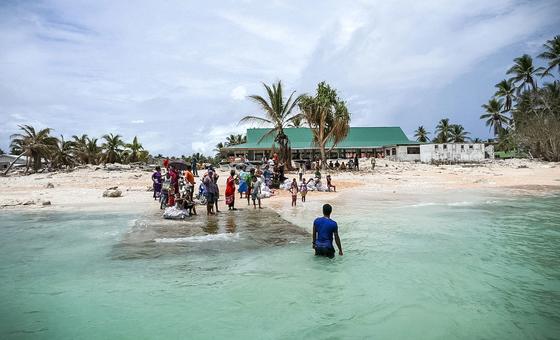 The community of Nui island waves goodbye to the Prime Minister of Tuvalu following his visit in the aftermath of the destruction of Cyclone Pam.