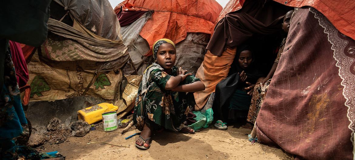 A young girl sits outside her family tent in at a camp for internally displaced people in Mogadishu.