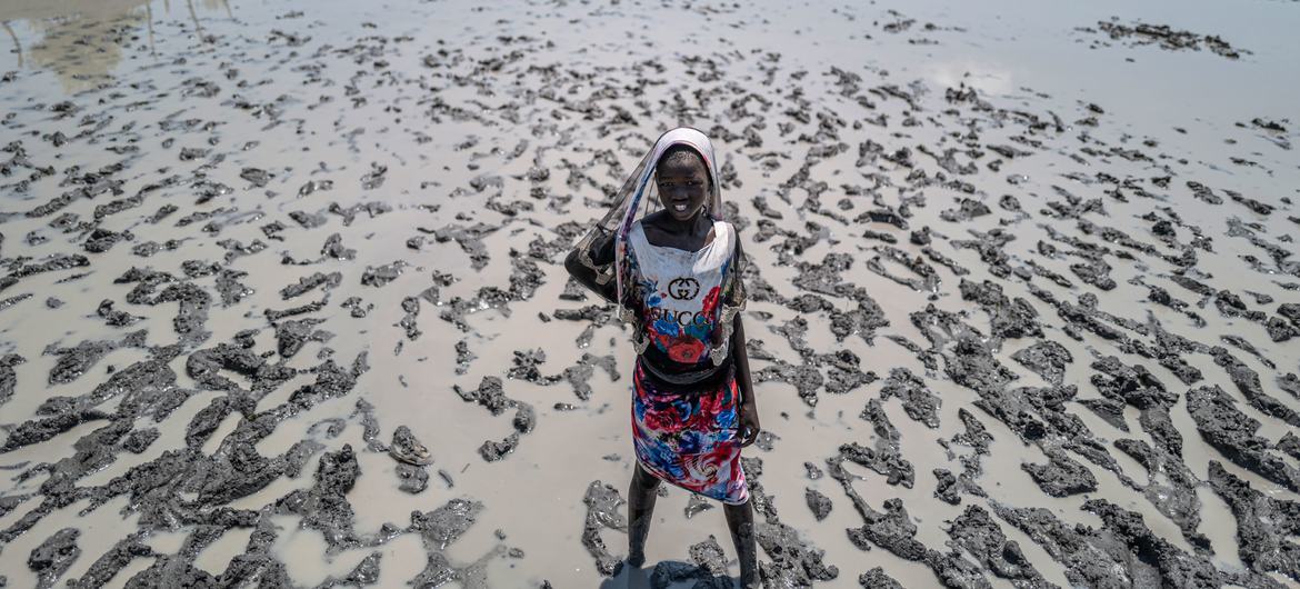 A young girl walks in the flooded village of Ulang in South Sudan.