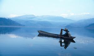 A man fishes on Lake Fewa in Nepal.